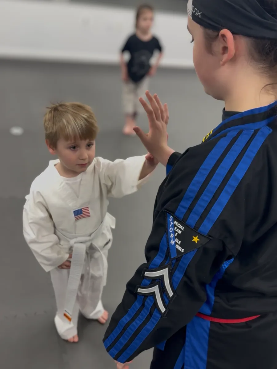 Preschooler high-fiving an instructor during Early Skillz class in South Jersey