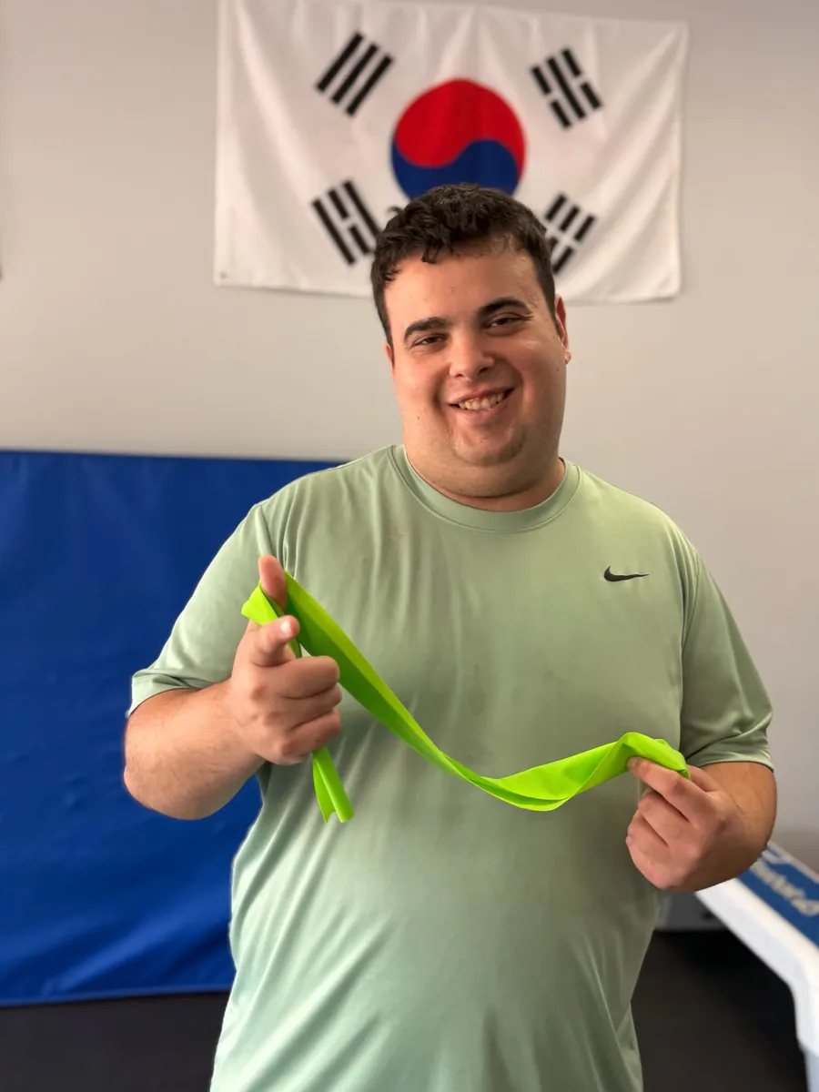 Adaptive fitness student training with a resistance band at Rise Up NJ in Atco