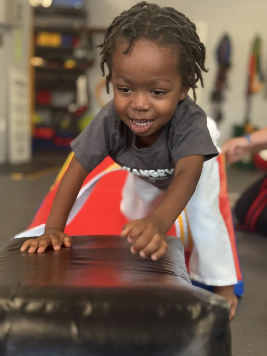 Toddler climbing over a padded obstacle at Rise Up NJ in Atco